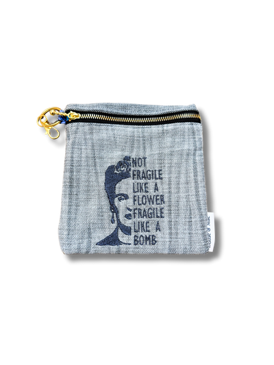 denim pouch with frieda kahlo quote "not fragile like a flower fragile like a bomb" on white background