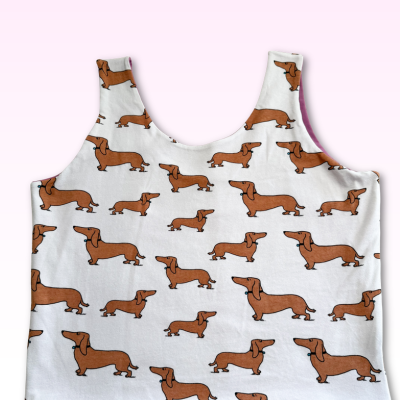 White top with brown dachshund dog pattern on a white background